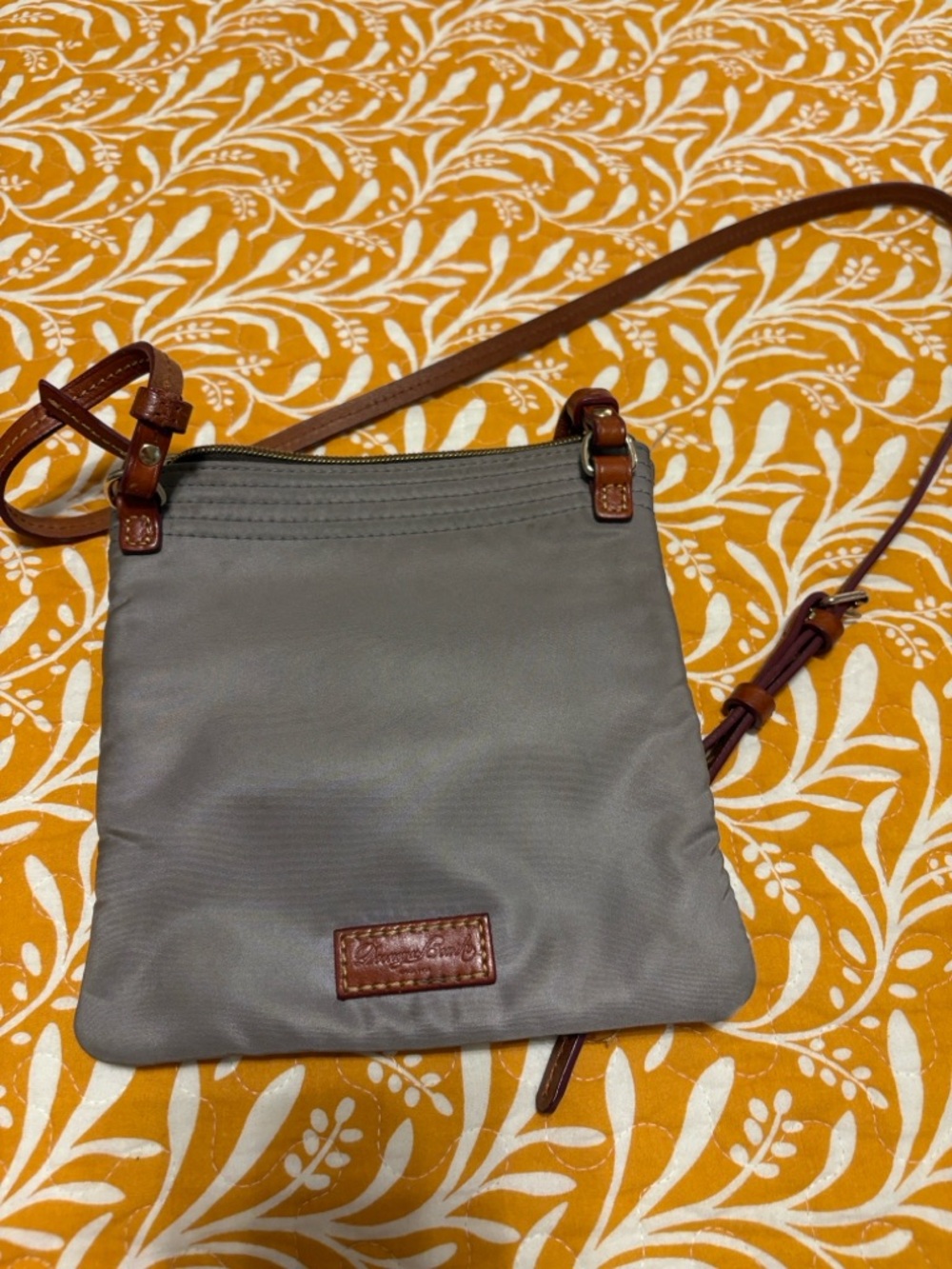 Gray Crossbody Bag with Brown Strap. Few loose thread on the strap, see photo.